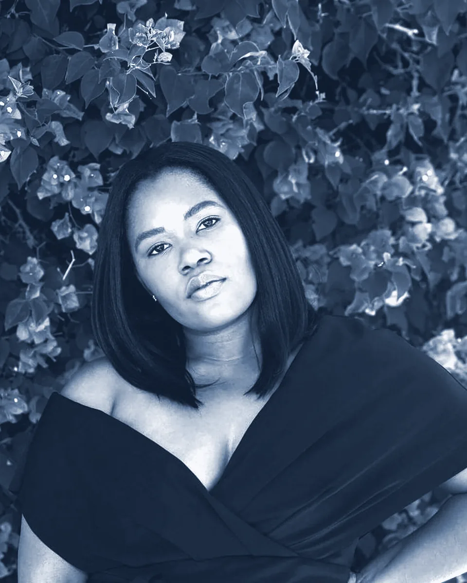Jamella Waller in front of a flowering vine